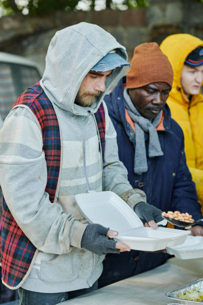 Good Junk team handing a turkey to a neighbor in need in Charleston, SC